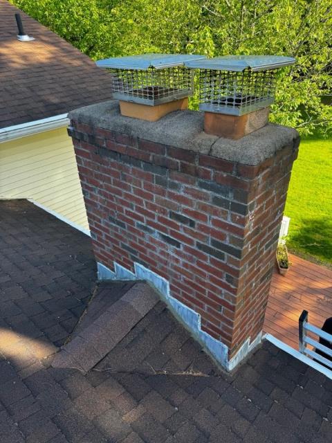 In South Windsor CT, The chimney has severe water and freeze-thaw damage causing cracks and structural weakness. It needs a full rebuild with new brick, lead flashing, and water repellent to prevent leaks and further damage.