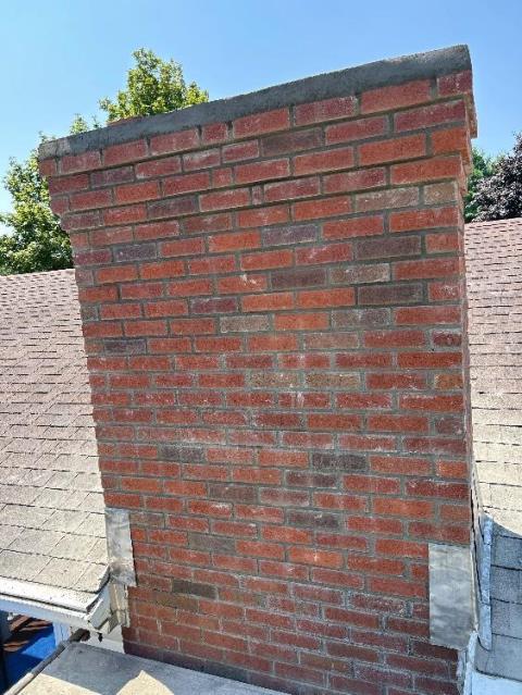 In South Windsor CT, The chimney has severe water and freeze-thaw damage causing cracks and structural weakness. It needs a full rebuild with new brick, lead flashing, and water repellent to prevent leaks and further damage.