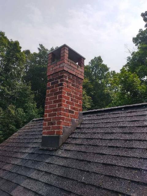 Collinsville Bluestone chimney cover collapsed and was blocking flue draft.  Top part of chimney was also deteriorated.  House is in a historical zone so expediency was required.  Rebult top few courses , new pillars and blue stone cap.