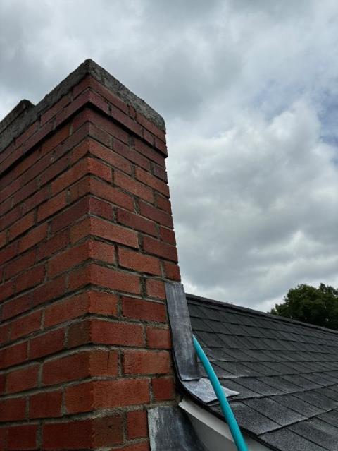 Bridgeport CT Top Of The Chimney Has Saturation and Structural Damages Developing Down to the Lower Roofline. Performed a roof up rebuild with new brick, cement, flashing, cap, and crown.