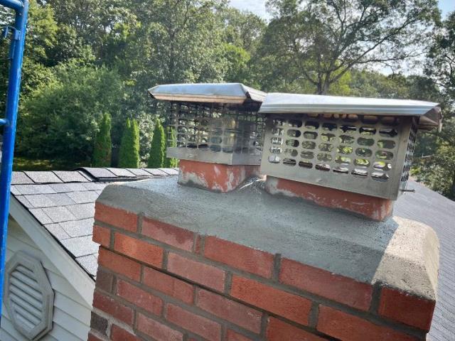 In South Windsor, CT, today, We rebuilt the top of the chimney and replaced damaged flue tiles to stop acidic exhaust from causing further deterioration. Mortar joints were repointed, and stainless steel caps reinstalled to preserve the structure.