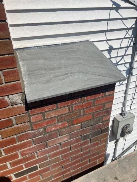 Enfield Ct Fireplace shoulder area was damaged. Common water pooling area so we rebuilt and installed a waterproof blue stone shoulder.