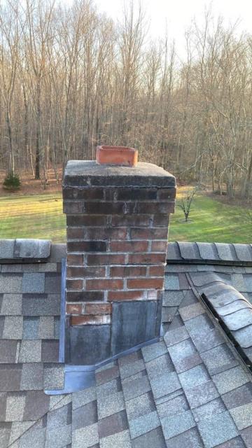 In Guilford CT, we rebuilt the chimney with all new materials, added a corbeled edge, and installed a new crown and flue tile. I also applied water repellent, installed a stainless-steel liner and cap, and finished with lead counter flashing. 