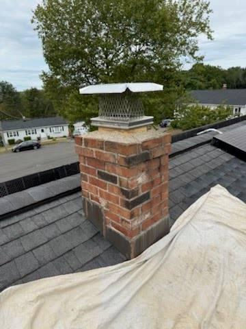 In Milford, CT, we dismantled and rebuilt the damaged chimney from the roofline up, ensuring structural integrity and proper water protection. A new stainless steel liner was installed to correct interior flue erosion and ensure safe venting of combustion gases.