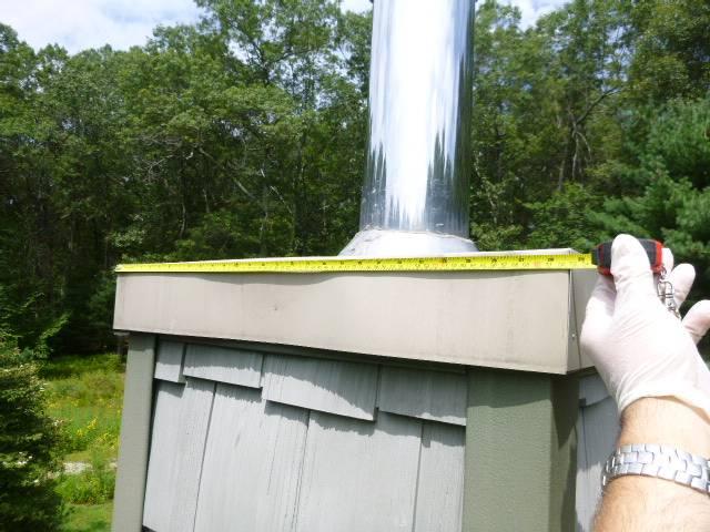 In Vernon, CT, The Front Chimney's Chase Pan is Pieced Together Sheet Metal With Silicone Used To Hold It Together. This Improperly Constructed Chase Cover Is Starting To Fail As Silicone Is Delaminating. Replaced with a new stainless steel chase pan.