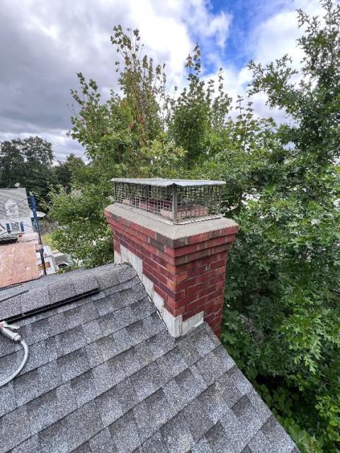 Leaking Fireplace In Manchester, CT, rebuilt top corbeled edge of damaged chimney exterior.  Installed a muti-flue chimney rain cap and applied commercial grade water repellent to help prevent future deterioration and protect the masonry structure