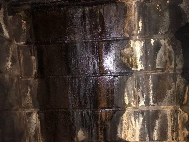 Leaking Fireplace In Manchester, CT, rebuilt top corbeled edge of damaged chimney exterior.  Installed a muti-flue chimney rain cap and applied commercial grade water repellent to help prevent future deterioration and protect the masonry structure