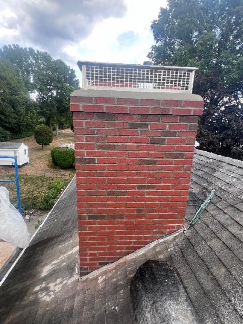 In Wethersfield, CT, We rebuilt the chimney from the roof up due to years of water damage and freeze/thaw deterioration. New brick, mortar, flue tile, and crown were installed to restore structure and prevent future leaking conditions.