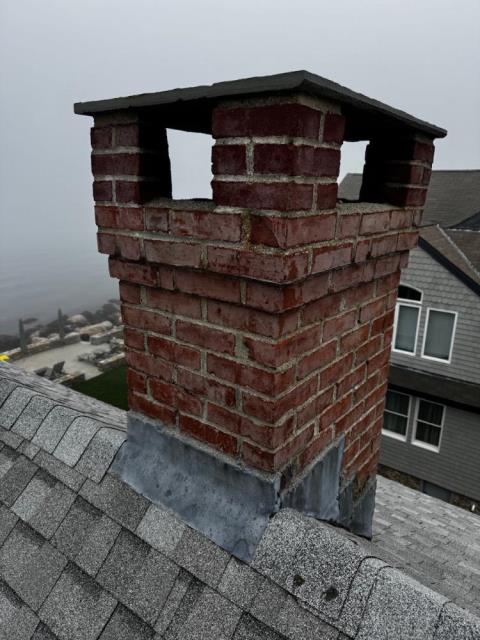 In Groton, CT, we rebuilt the chimney from the roofline up due to extensive freeze-thaw damage and structural deterioration. New lead flashing and crown were installed to ensure long-term protection.