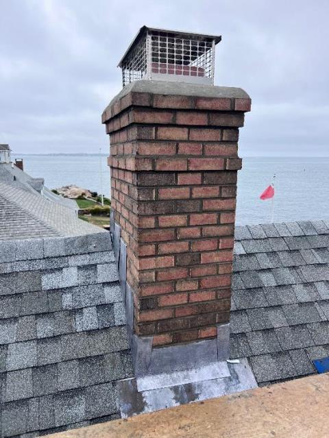 In Groton, CT, we rebuilt the chimney from the roofline up due to extensive freeze-thaw damage and structural deterioration. New lead flashing and crown were installed to ensure long-term protection.