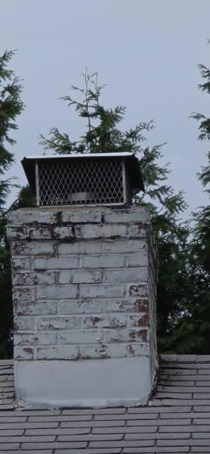 We installed a stainless steel 2-ply smooth wall liner from the high-efficiency oil boiler to the top of the chimney. This resolved unsafe venting issues and helped protect the masonry structure from further damage.