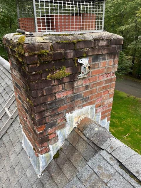 Chimney rebuild Guilford Ct roofline up with a new stainless steel chimney liner.