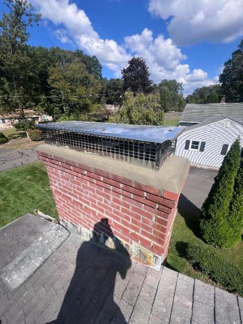 In Enfield, CT, we applied a water repellent to protect the masonry from moisture intrusion and chemical damage. We also replaced the cracked chimney crown to prevent further water penetration and deterioration.