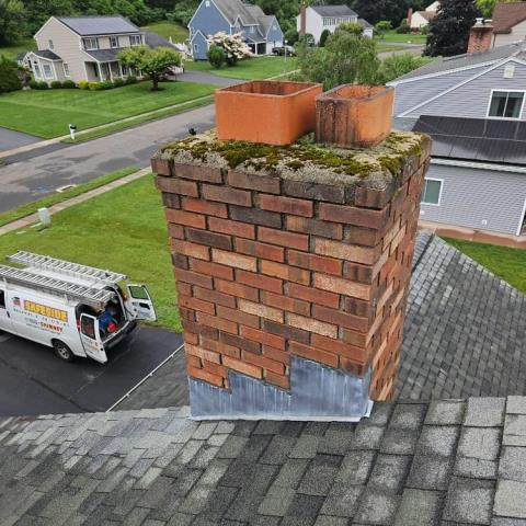 Moss covered crown in Plantsville ct – Removed and replaced cement crown and install a rain cap to protect the chimney from rain and snow.