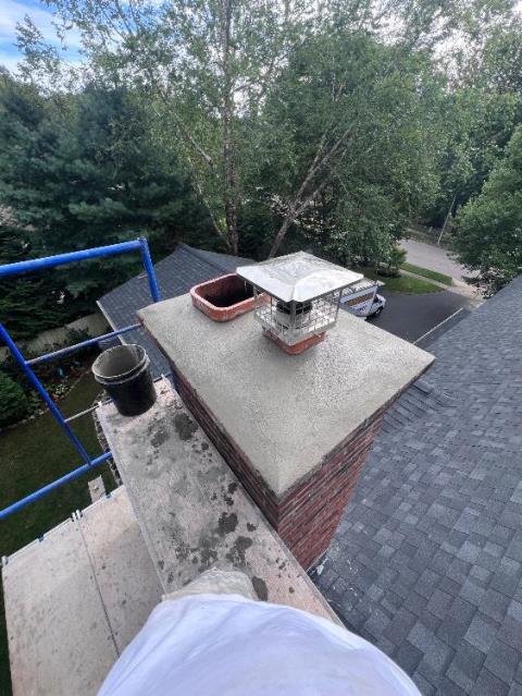 In Groton, CT, we installed a stainless steel liner system to safely vent acidic exhaust from the high-efficiency oil furnace. We also repaired the chimney crown, replaced damaged flue tiles, and installed stainless steel caps to protect both venting systems.