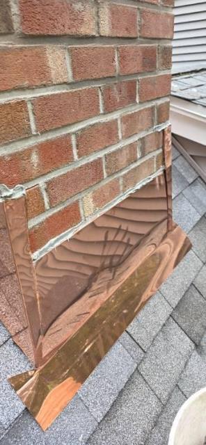 Upgraded chimney flashing with new copper counter flashing to resolve water entry issues.