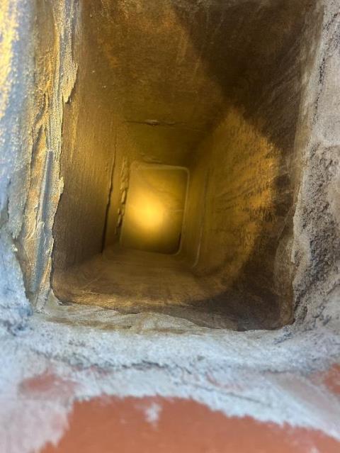 In Bloomfield, CT, We mechanically deglazed the terracotta clay flue tiles to remove stage three creosote. This improved safety and draft efficiency.