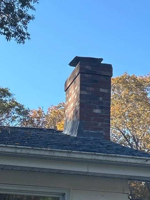 In Groton CT We removed the damaged chimney structure down to the roofline and rebuilt it with all new brick, cement, and flashing. We reconstructed the crown with a proper drip edge and installed a stainless steel cap to protect the flue.