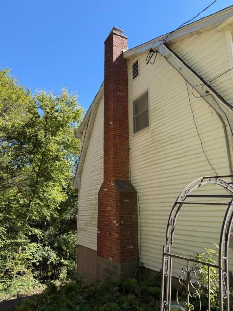 In Tolland, CT, we installed a UL-listed stainless steel chimney liner system to address interior flue damage caused by condensation. This restored safe venting of combustion by-products and protected the chimney structure from further deterioration.