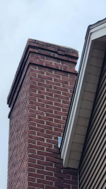 Deep River Ct Masonry Repair.  Rebuilt the top damaged crown and deteriorated upper brick courses. Installed new stainless steel rain/snow caps to protect the chimney flues.