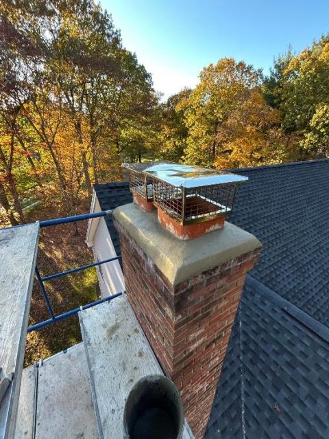 In Glastonbury, CT, we remortared the fractured chimney crown with waterproof cement to stop water entry and protect the masonry structure. We installed two stainless steel caps to seal and safeguard both venting systems from weather and animals.
