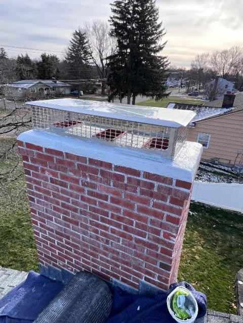 In East hartford CT We rebuilt the damaged top courses of the chimney to restore structural integrity. We installed new flue tiles, brickwork, crown, and protective cap.