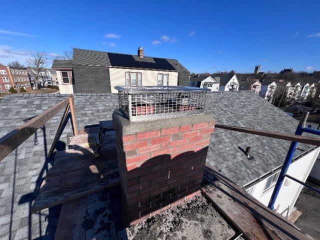 In Hartford CT We found sulfuric acid damage causing loose brick and leaks. We rebuilt the chimney top with brick, crown, and cap.