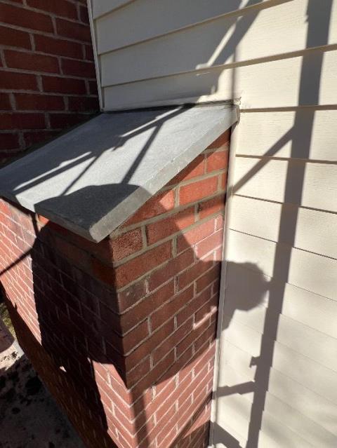 We rebuilt the damaged chimney shoulder shelf with new brick, mortar, and a one-piece bluestone cap. We also rebuilt the chimney crown to stop leaks and protect the masonry structure.
