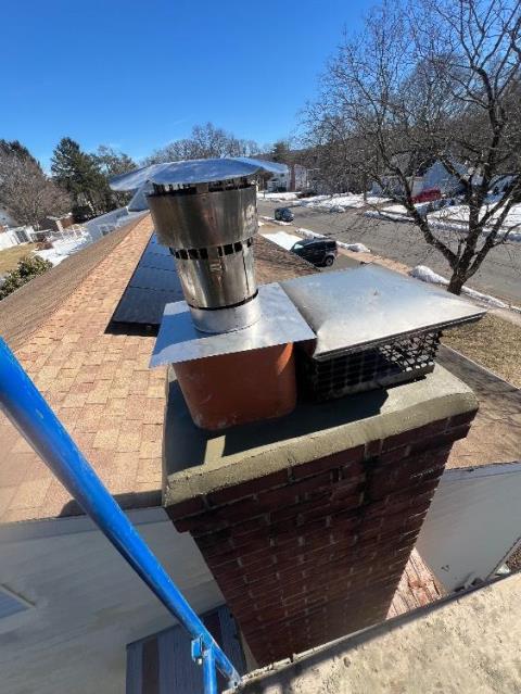 We rebuilt the damaged chimney shoulder shelf with new brick, mortar, and a one-piece bluestone cap. We also rebuilt the chimney crown to stop leaks and protect the masonry structure.