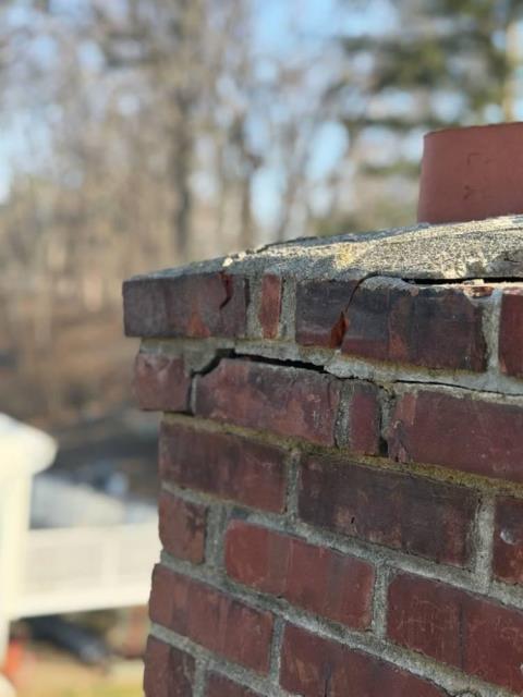 We repaired the fractured chimney crown and top two rows of bricks and sealed it with waterproof cement. We applied water repellent and reinstalled the cap.