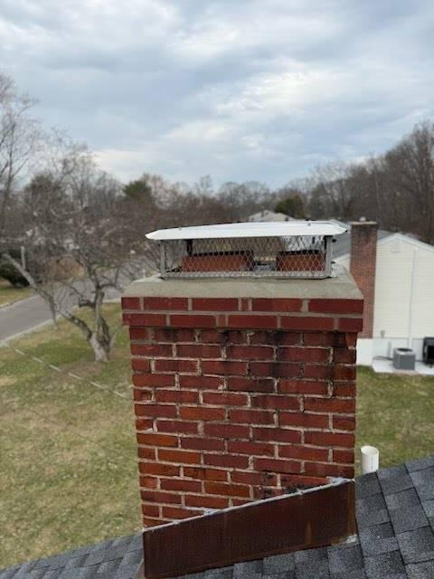 We repaired the fractured chimney crown and top two rows of bricks and sealed it with waterproof cement. We applied water repellent and reinstalled the cap.