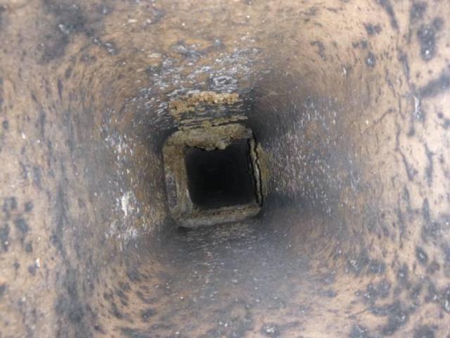 We installed a stainless steel liner to safely vent the oil boiler and prevent acidic exhaust damage. We rebuilt the chimney crown, replaced damaged flue tiles, and removed combustible materials for safety.