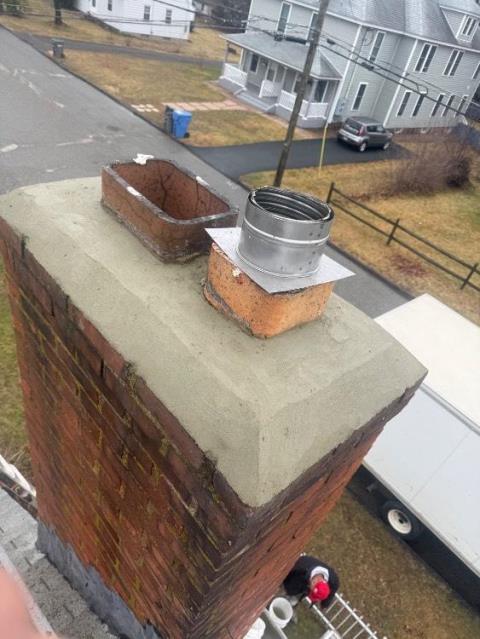 We installed a stainless steel liner to safely vent the oil boiler and prevent acidic exhaust damage. We rebuilt the chimney crown, replaced damaged flue tiles, and removed combustible materials for safety.
