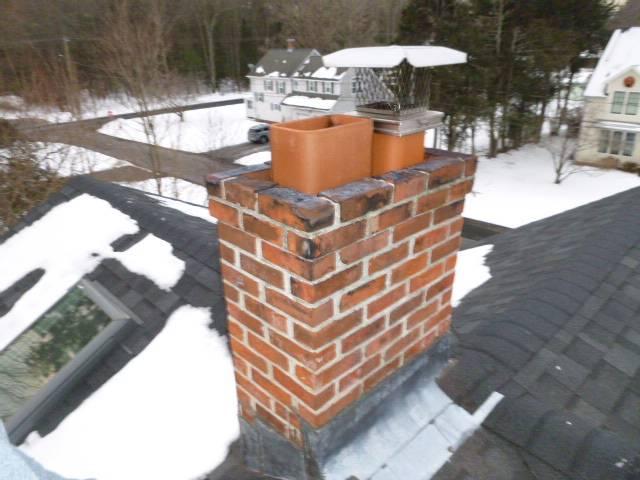 We installed a properly sized stainless steel liner to correct venting issues and protect the chimney structure. We rebuilt the crown, repointed mortar joints, and installed new caps to improve draft and prevent water damage.