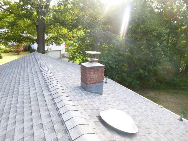 In East Haven, CT, We removed and rebuilt the chimney with new brick, cement, flashing, flue tiles, and crown.