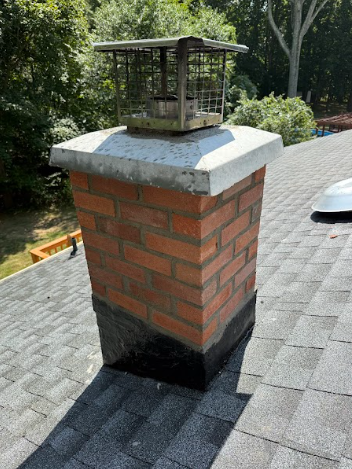 In East Haven, CT, We removed and rebuilt the chimney with new brick, cement, flashing, flue tiles, and crown.