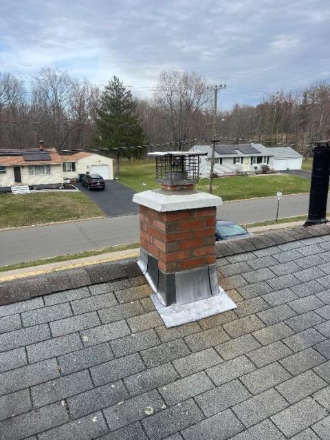 We rebuilt the chimney from the roofline up including installation of a precast chimney crown, correcting severe acid damage and structural deterioration. We insulated the liner to reduce condensation and protect the masonry system.