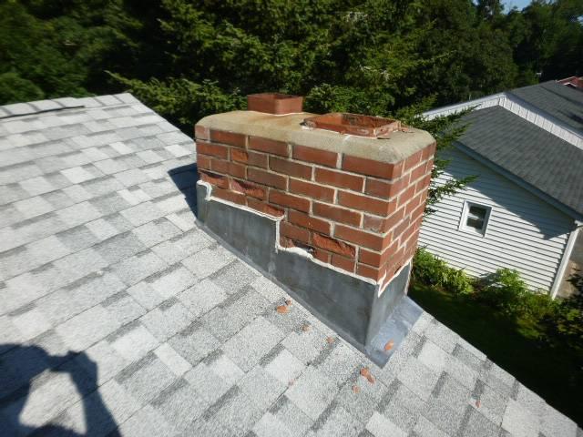 We installed an insulated stainless steel liner system to correct unsafe venting and contain acidic moisture. We rebuilt the chimney and reconstructed the smoke chamber to meet current clearance and code requirements.