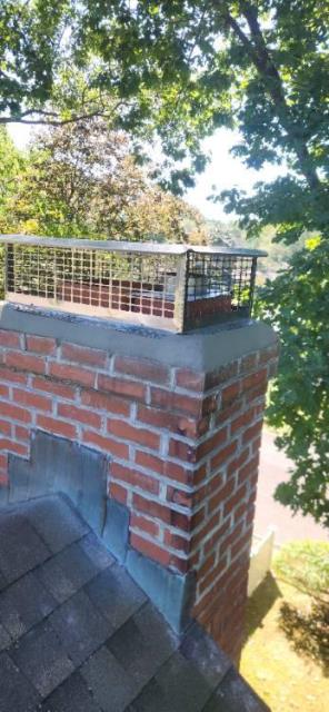 We installed a properly sized liner for the oil furnace venting system. We replaced the crown, flue tile, and chimney cap to improve protection and performance.