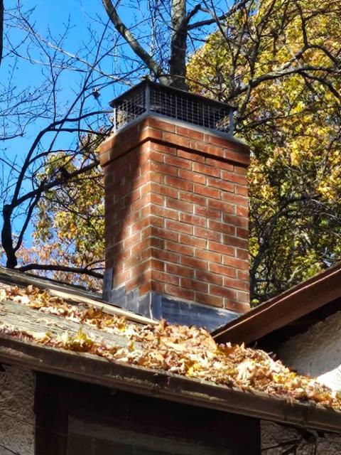 In Hartford, CT, the chimney has suffered extensive exterior damage from years of water penetration and freeze/thaw cycles, resulting in cracked bricks, missing mortar, and compromised structural integrity requiring a full rebuild from the roofline up. The project includes proper lead flashing installation, a new top flue tile, cement crown, and high-quality masonry work to prevent future leaks and deterioration.