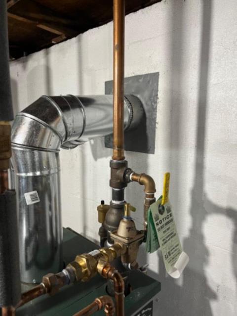 Installation of a new chimney liner system due to rotted original flue tile in Groton Ct home , we also replaced the rusted connector pipe to safely vent the  furnace.
