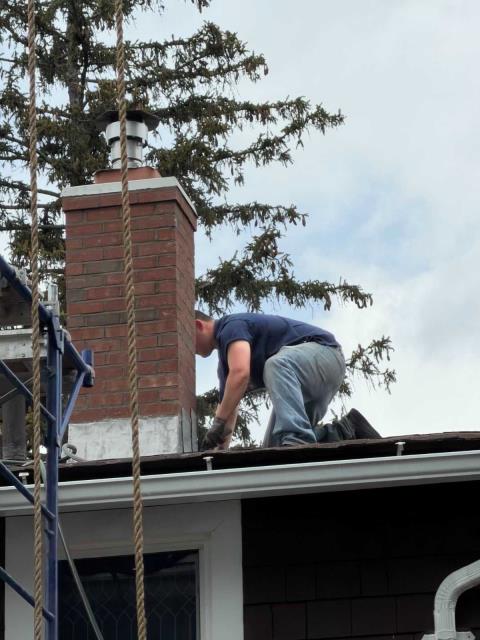 We rebuilt chimney from roofline up with new brick, mortar, flue section, crown, and lead flashing. We addressed water damage and structural failure.