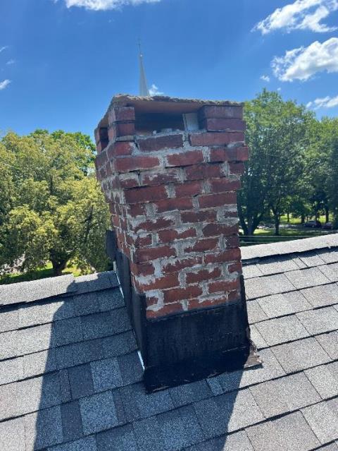 Roof up rebuild in West Hartford, CT with new brick, cement, flashing, flue tiles, crown, and a stainless cap going in to restore safety and function!