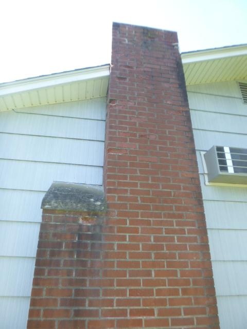 In Windham, CT, We installed an insulated stainless steel liner to safely vent exhaust and prevent further chimney deterioration. The chimney was then fully rebuilt with new brick, flue tiles, crown, flashing, and cap.