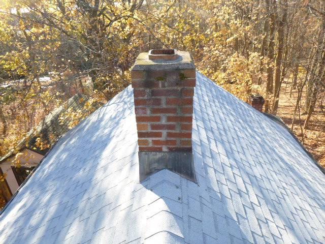 Manchester ct chimney crown had some minor water damage. The furnace flue did not have a rain cap , allowing years of water to enter flue tile system accelerating damage.  Installed a new chimney liner system with a rain cap  , and performed a crownseal to protect the top.