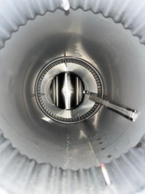 The high-efficiency oil burner is causing condensation that mixes with soot to form sulfuric acid, which has severely damaged the chimney’s flue tiles and mortar joints, leading to structural deterioration. Installing a properly sized stainless steel liner from the boiler to the chimney top will ensure safe venting and protect the chimney’s structure from further acid damage.