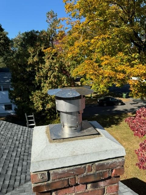 In Windsor, CT, the high-efficiency Beckett AFG oil burner is causing condensation that mixes with soot, forming sulfuric acid, which has damaged the chimney’s flue tiles and mortar joints, allowing exhaust and moisture to bypass the venting system. To fix this, a stainless steel 2-ply smoothwall liner was installed to ensure safe venting and protect the chimney structure. Additionally, the fractured and eroded cement crown was removed and replaced to properly shed water and prevent further structural damage.