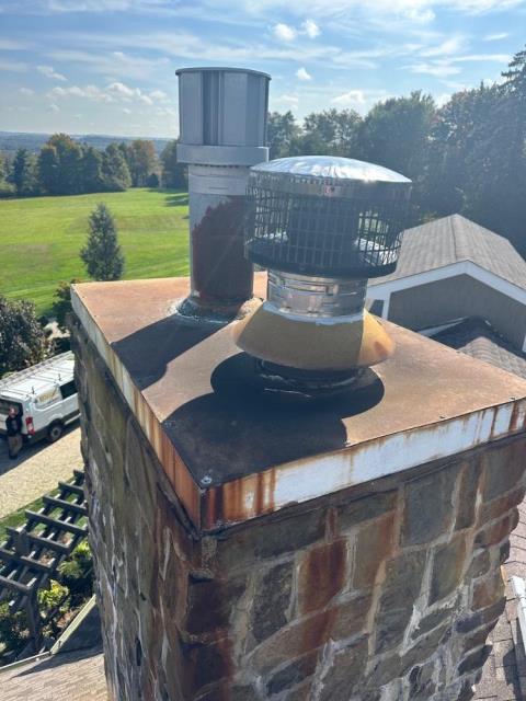 A chase pan is a cover that protects the top of a framed chimney from water, animals, and debris, but builder-grade galvanized metal versions often deteriorate and allow water intrusion.  We installed a stainless steel pan with proper overhangs and pitched cross breaks so water won’t pool.