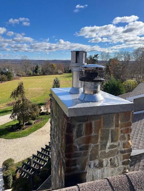 A chase pan is a cover that protects the top of a framed chimney from water, animals, and debris, but builder-grade galvanized metal versions often deteriorate and allow water intrusion.  We installed a stainless steel pan with proper overhangs and pitched cross breaks so water won’t pool.