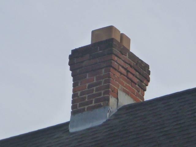 We rebuilt the chimney to the roofline with new brick, crown, flashing, flue tiles, and protective caps. We corrected structural damage and restored safe venting for the fireplace, hot water, and heating systems.